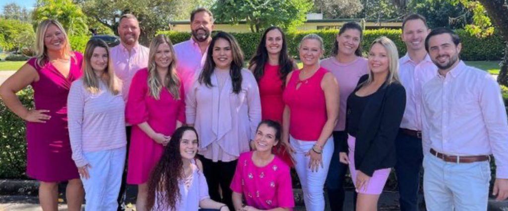 Cottrell Title team wearing assorted colors of pink for Breast Cancer Awareness Month
